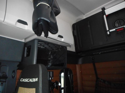 Freightliner Cascadia 126 cab interior showing storage compartments and seat with Cascadia logo.