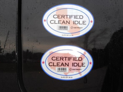 Freightliner Cascadia 126 badge stickers showing Certified Clean Idle emblems on a dark surface.