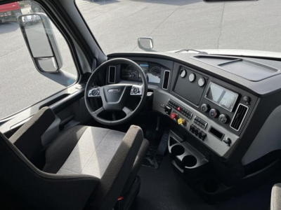 Freightliner Cascadia 126 truck cab interior showing steering wheel, dashboard, and control panel.
