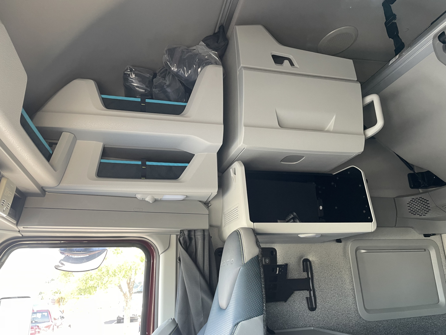 Volvo VNL64T860 cab interior showing storage compartments and center console in-view