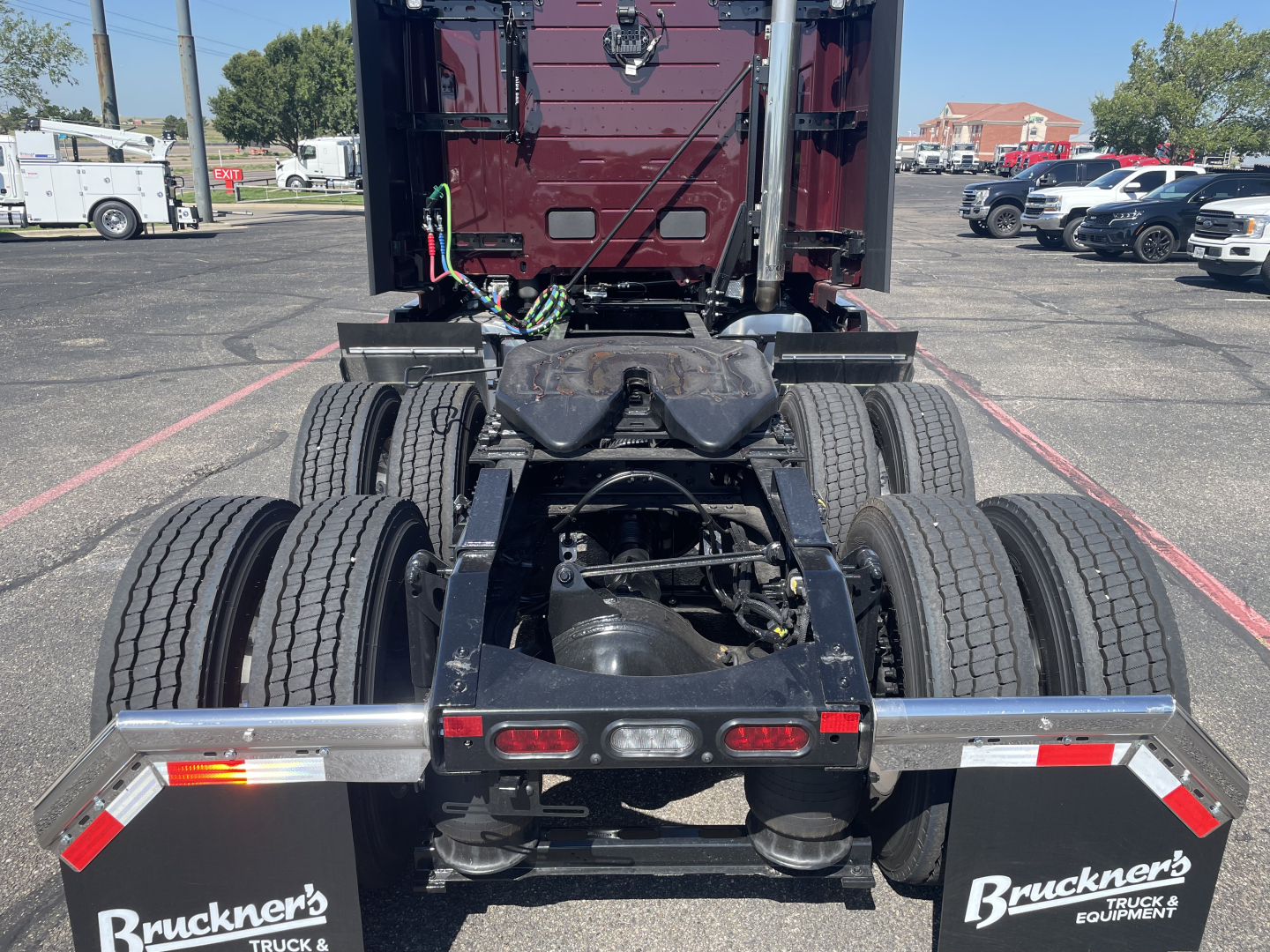 Volvo VNL64T860 tractor rear view showing fifth-wheel hitch, dual rear axles, and bumper with Bruckner’s Truck & Equipment logo.