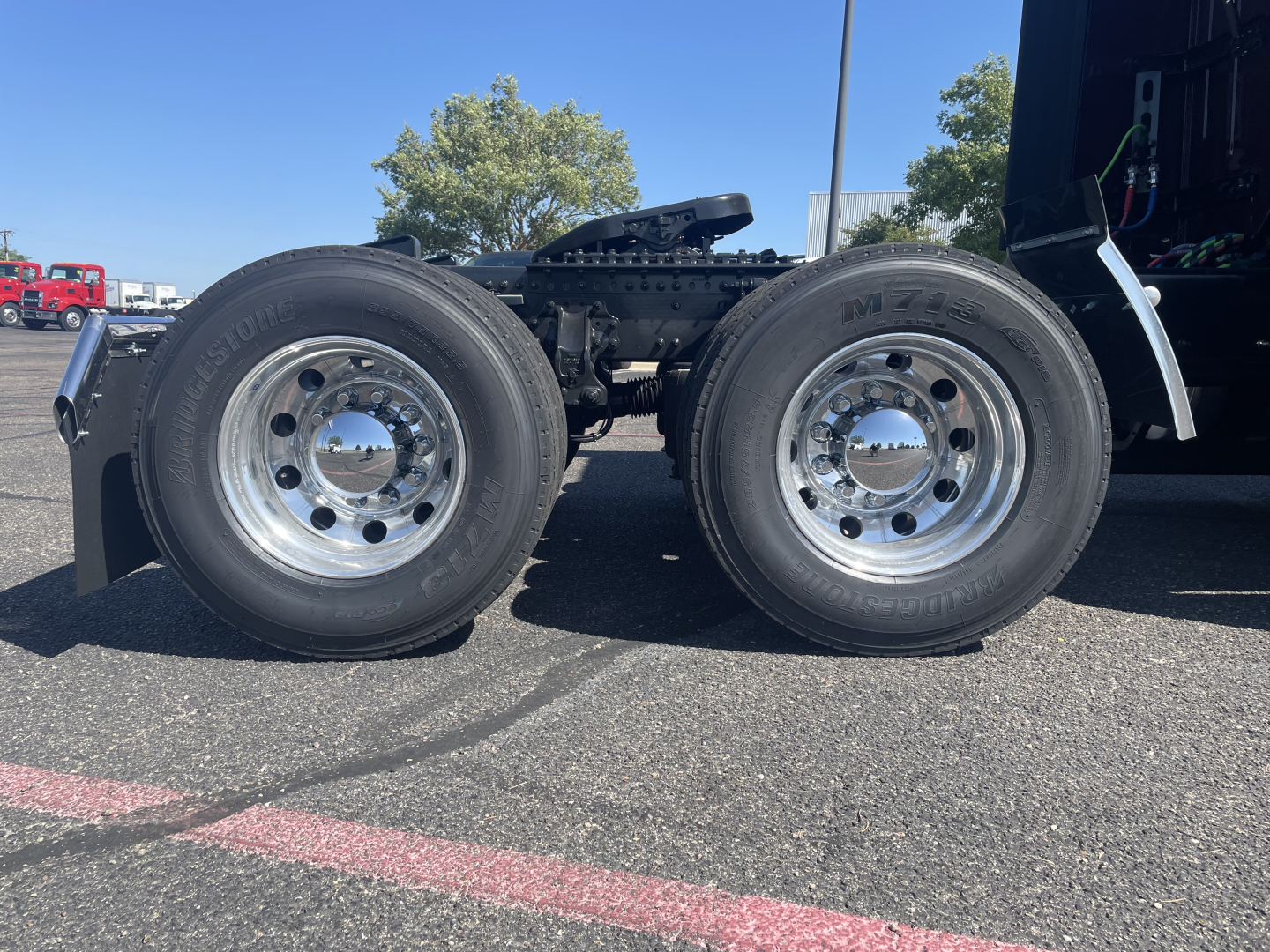 Volvo truck twin rear dual wheels showing wheel tires and chrome rims in side view.