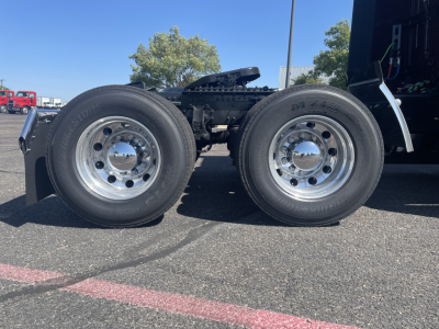 Volvo truck twin rear dual wheels showing wheel tires and chrome rims in side view.