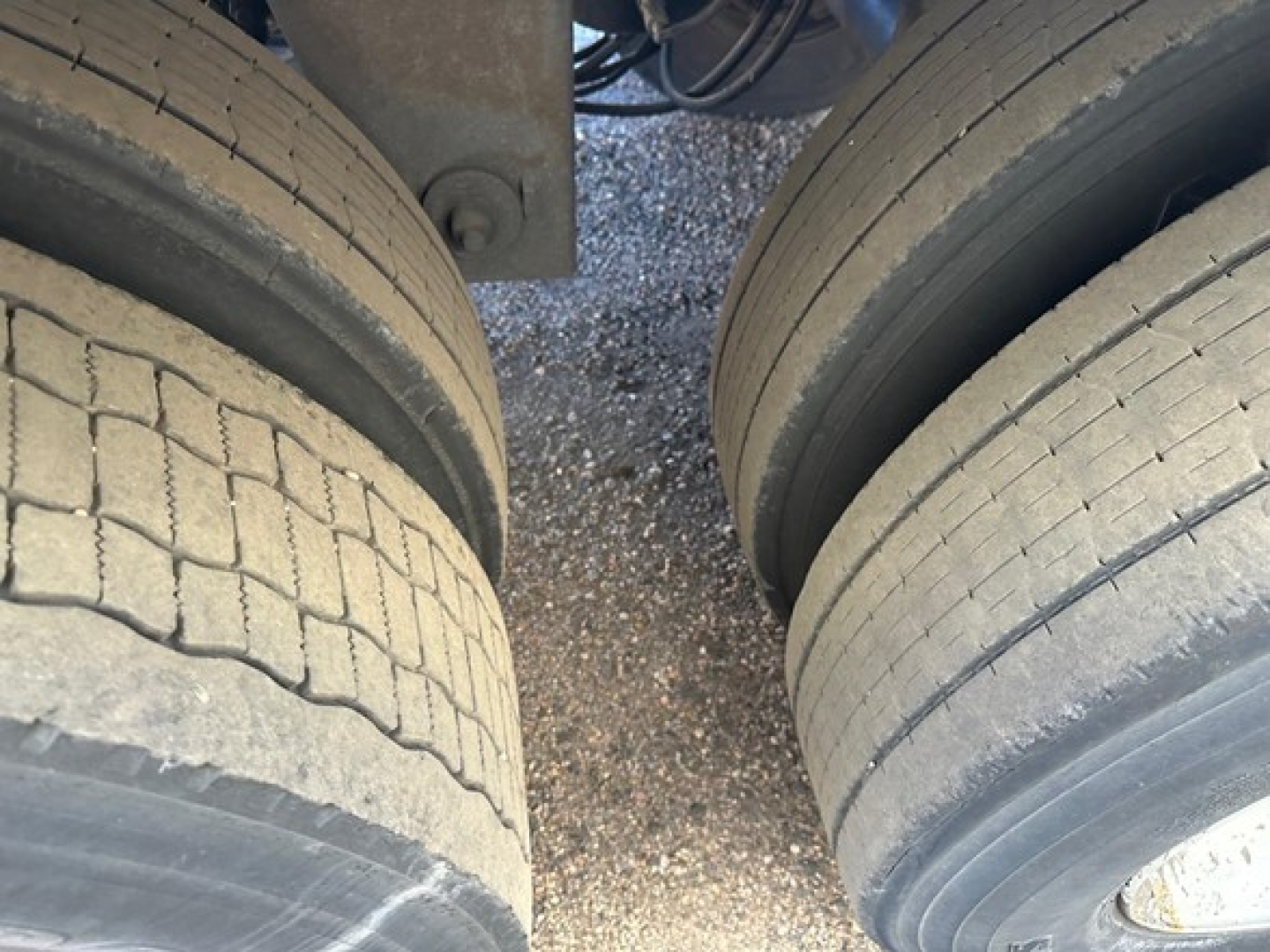 Hyundai air ride dry van trailer wheel area showing dual rear axles with worn tread and wearband; part of undercarriage visible.