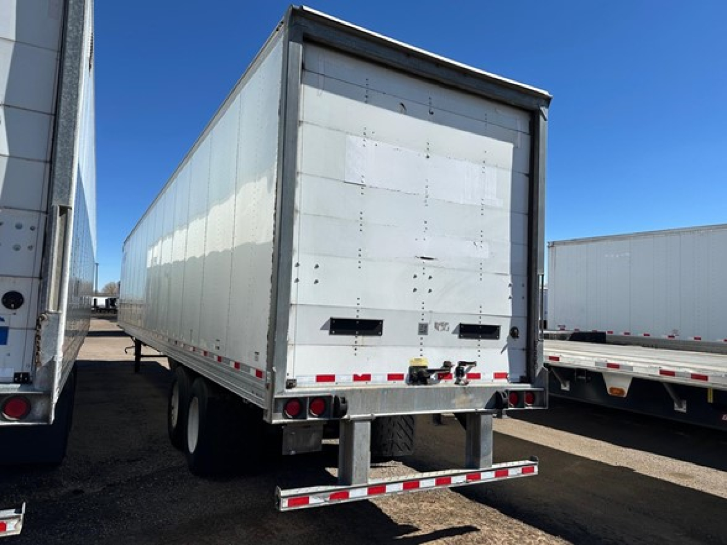 Trailer back view showing Hyundai air ride dry van with roll-up door, wearband, dual rear doors, and bumper with reflective tape.