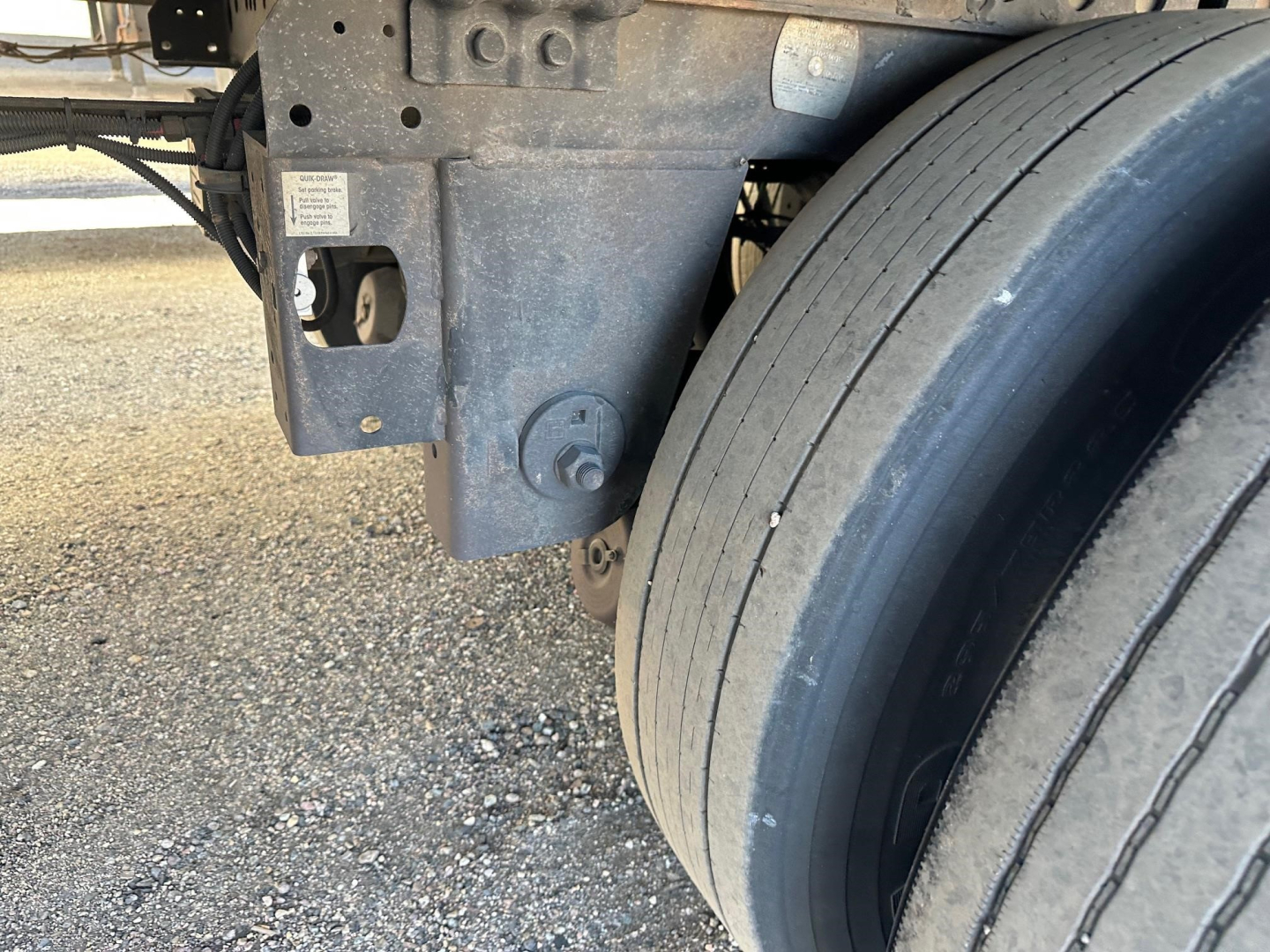 Hyundai air ride dry van trailer showing dual rear axle and suspension mounting with a large wheel and frame components.