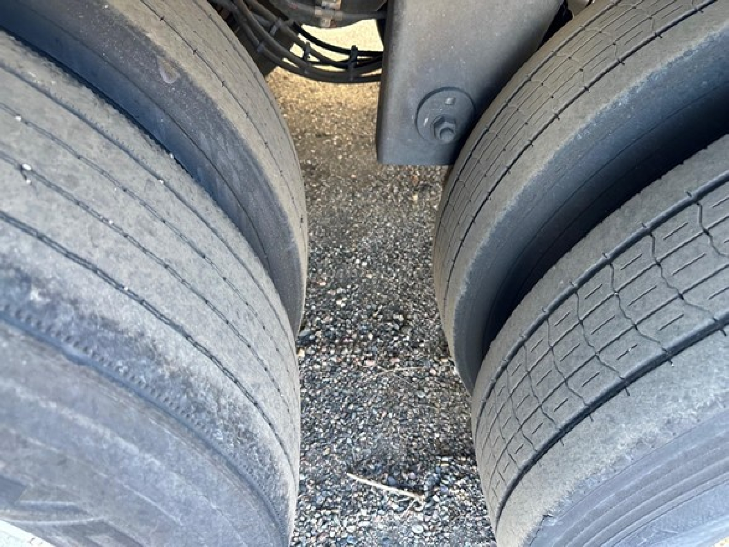 Rear wheels of a Hyundai air ride dry van trailer showing dual axles and tire treads with fifth-wheel hitch area visible.