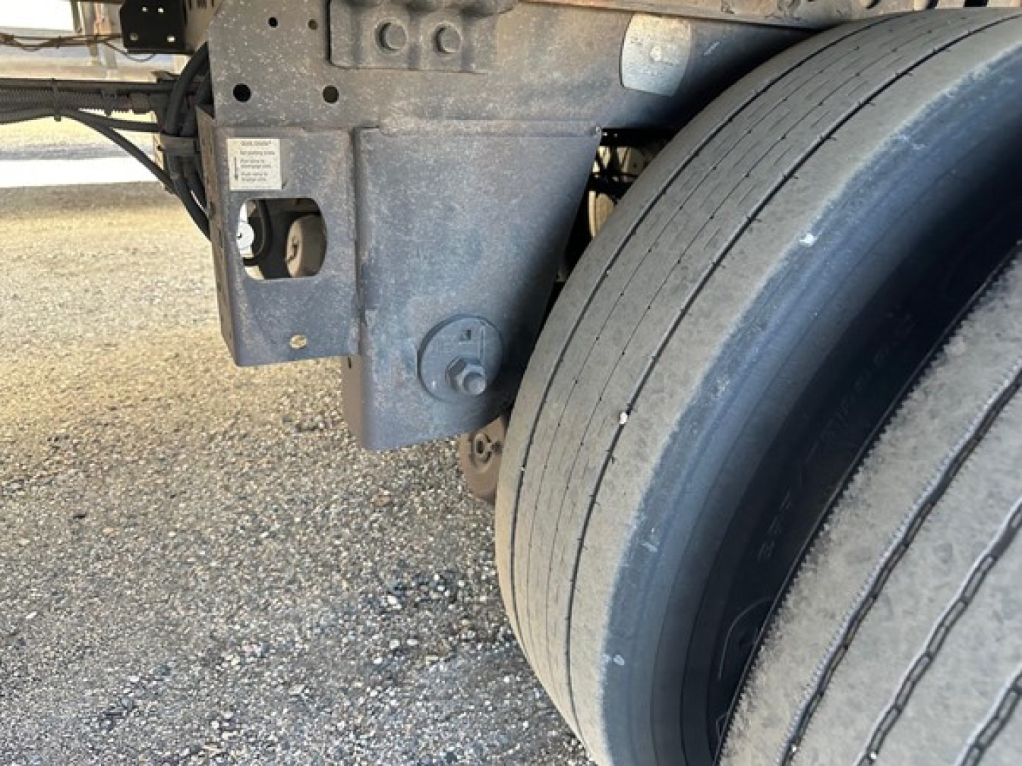 Hyundai trailer undercarriage with dual rear tires and air ride suspension, visible mounting brackets and labeling plate.