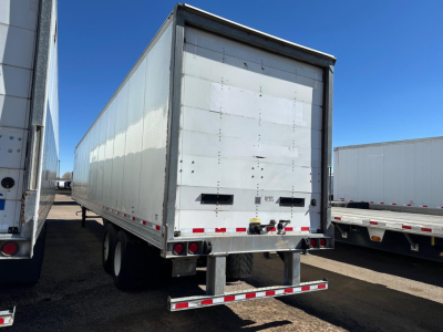 Trailer back view of a 2015 Hyundai air ride dry van with roll-up rear door and dual rear axles.