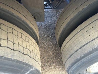 Hyundai air ride dry van trailer wheel area showing dual rear axles with worn tread and wearband; part of undercarriage visible.
