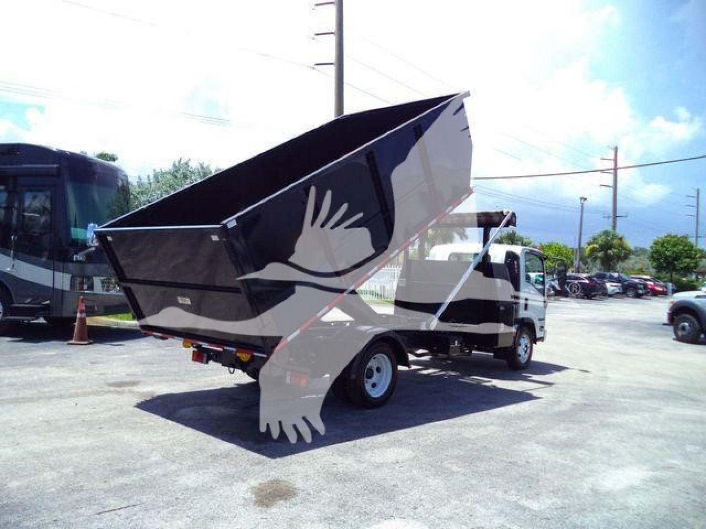 Isuzu NPRR rolloff truck in-service view showing tipped bed and side profile with white bird watermark overlay.