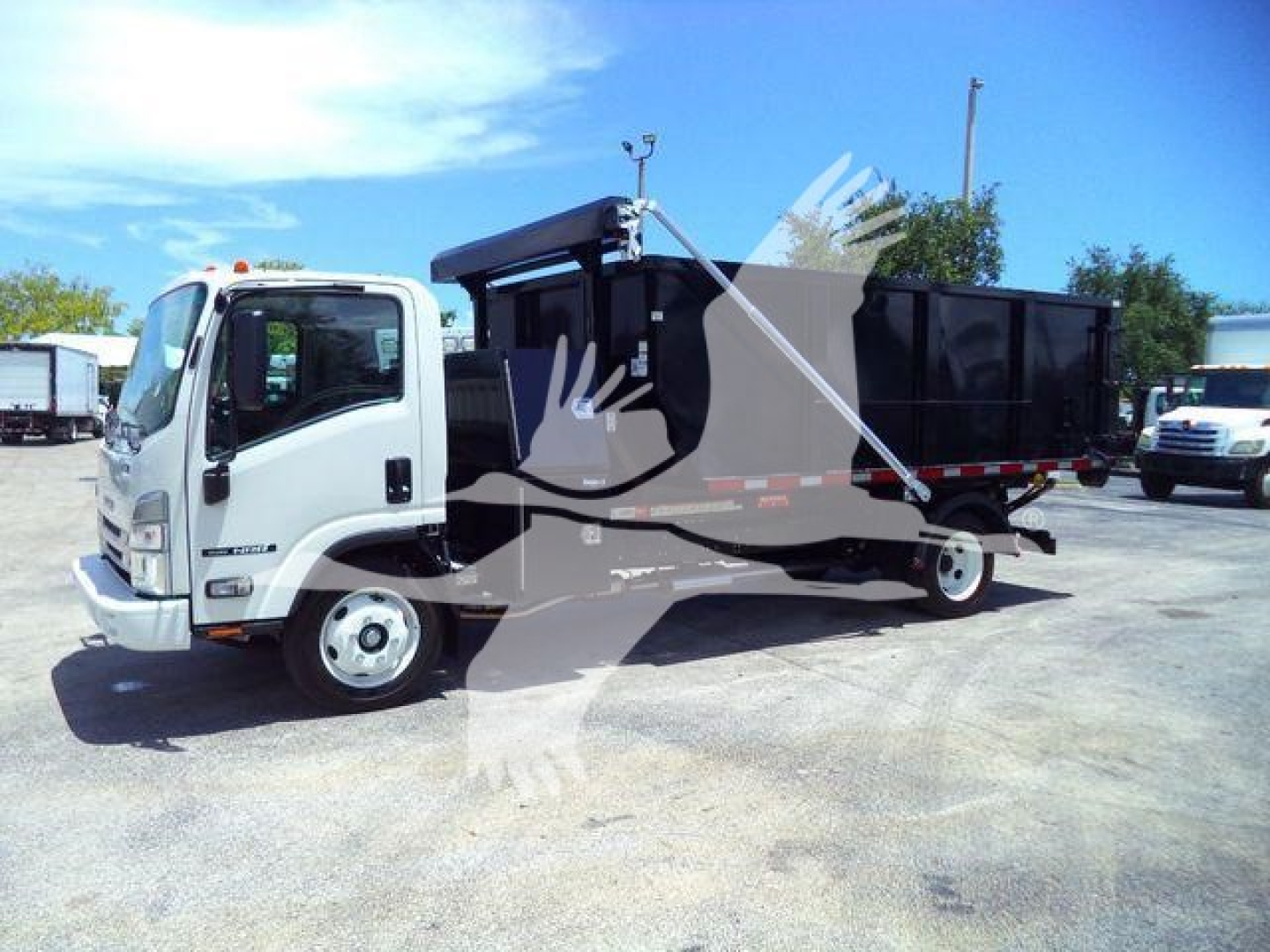 Isuzu NPR/G-series roll-off truck with dump bed, side view showing cab and cargo body, no visible text on side except generic markings.