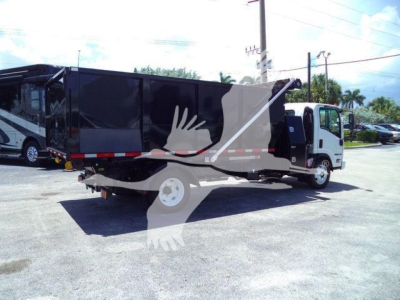 Isuzu NPRR roll-off truck in service bay showing side view with black dump body and white cab; stock number GASNRR14SNG2; new/used status: new.