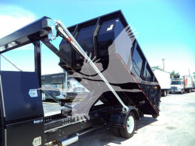 Isuzu NRR roll-off truck bed in raised position showing hydraulic arms and refuse container mounting area.