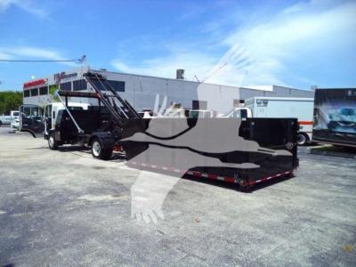 Isuzu NRR roll-off truck with hydraulic arm and black container, side view, outdoor lot.