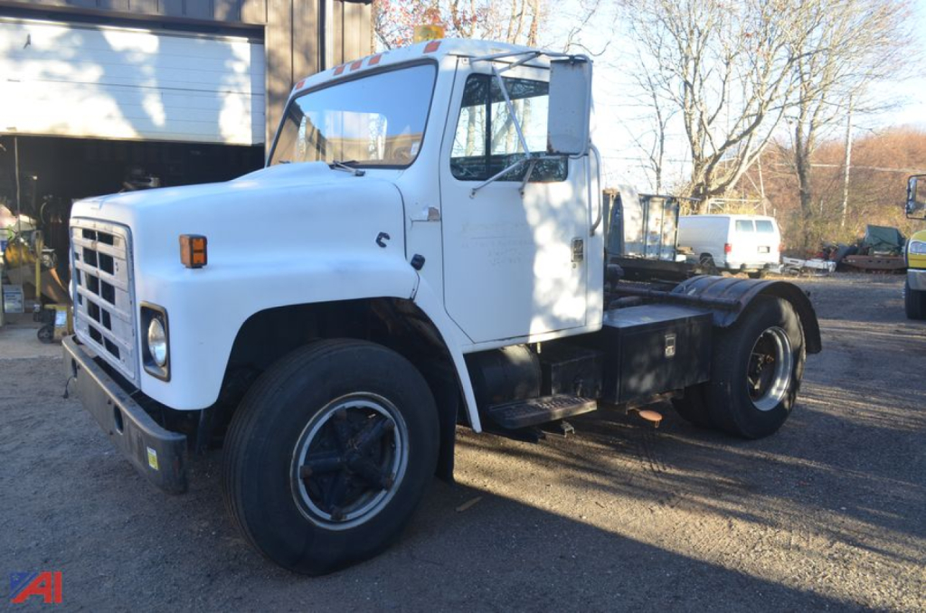 1988 International 1654 tractor truck in white, side view showing cab and chassis, no trailer, daytime outdoors