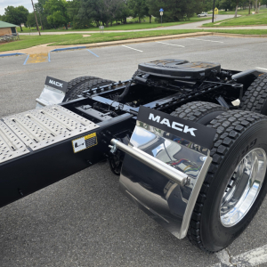 Mack PI64T truck chassis showing chrome fuel tank cover and rear dual wheels with Mack branding on fenders.