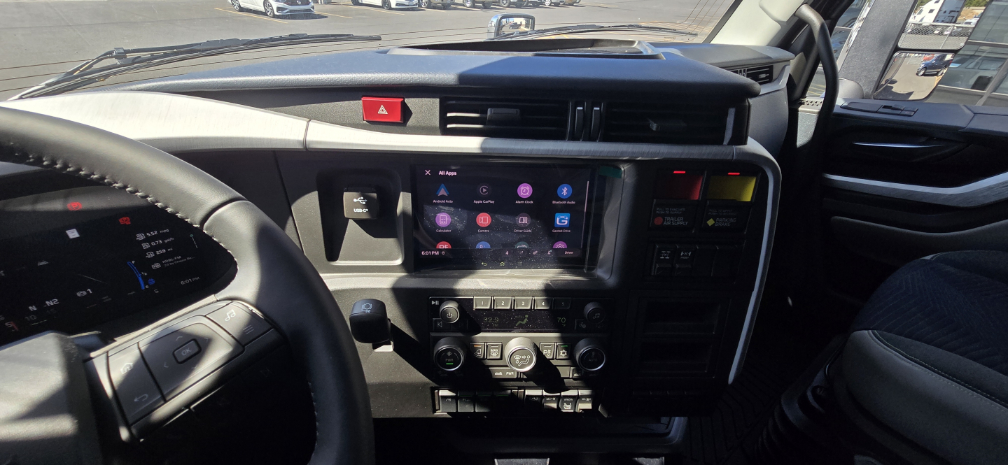 Volvo VNL dashboard interior displaying digital infotainment screen and control cluster.