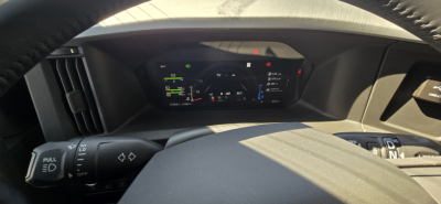 Volvo VNL cabin dash view showing digital instrument cluster and steering wheel controls.