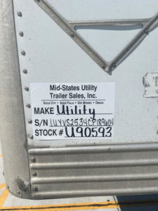 Trailer door with label from Mid-States Utility Trailer Sales, Inc. showing VIN 1UYVS2534CP189604 and stock number U90593.