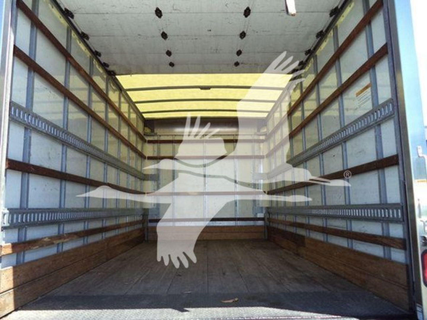 Isuzu NPR HD cargo truck box interior showing empty bed with wooden sidewalls and metal rails