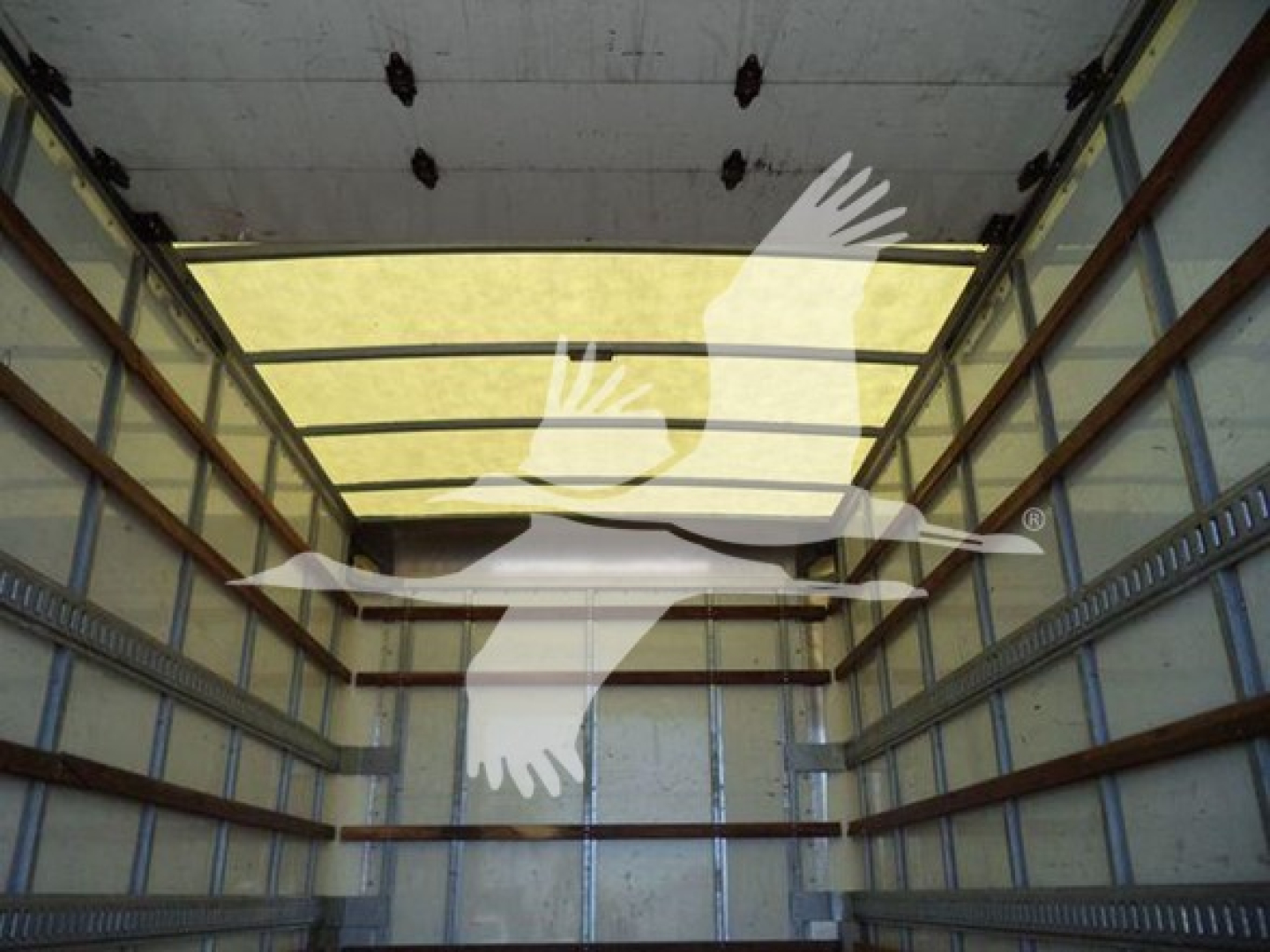 Isuzu NPR HD box truck cargo area with empty interior walls and roof beams visible.