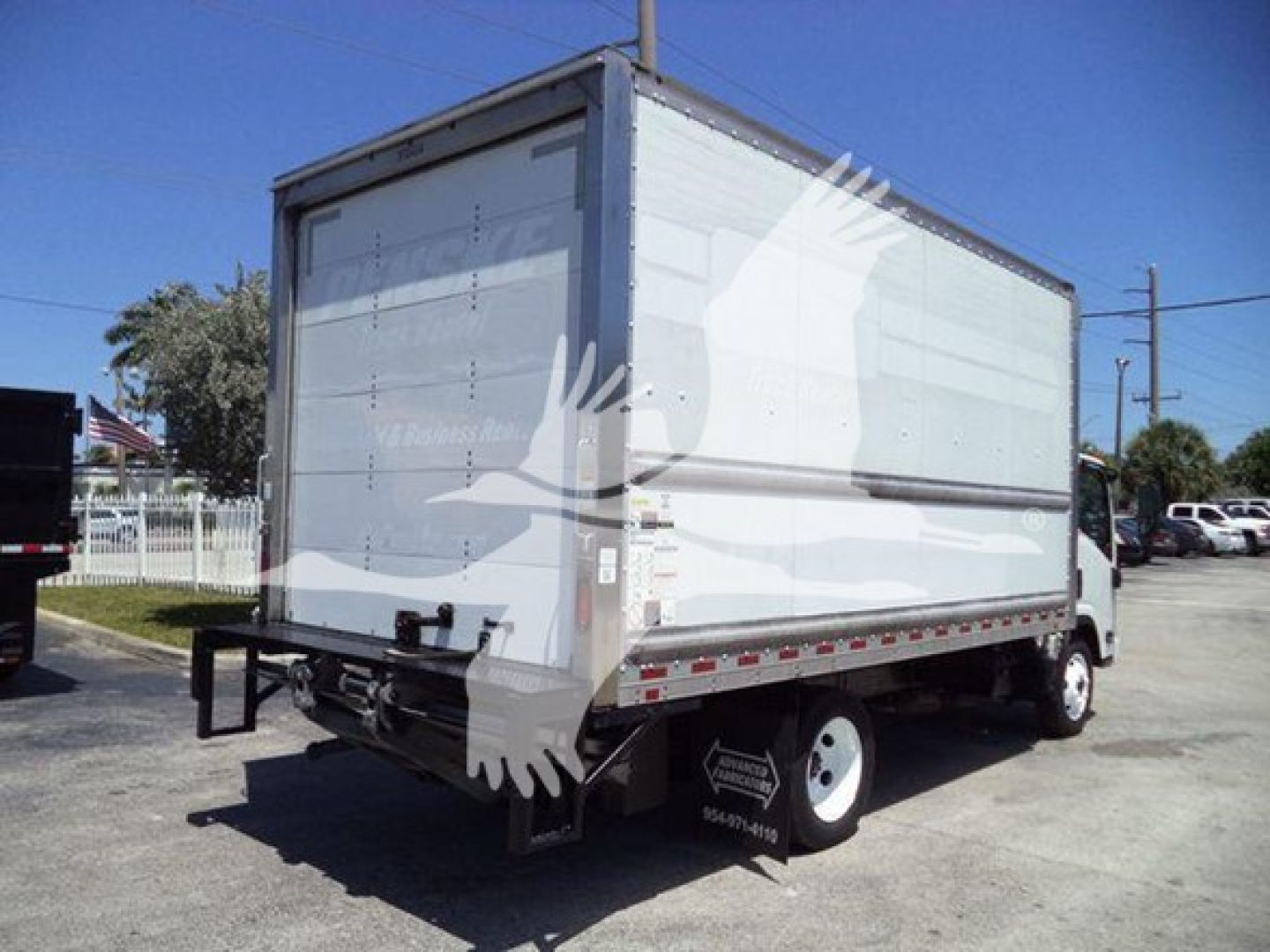 Isuzu NPR-HD box truck rear and side view showing cargo box and rear bumper.