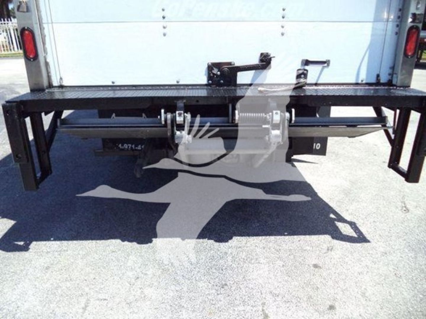 Isuzu NPR HD truck rear with black steel bumper/ hitch apparatus and reflective light, stock number plate area visible.