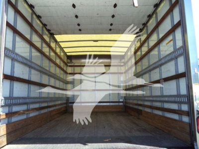 Isuzu NPR HD cargo truck box interior showing empty bed with wooden sidewalls and metal rails
