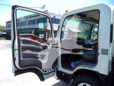 Isuzu NPR-HD truck cab interior with open driver and passenger doors, showing steering wheel and dashboard.