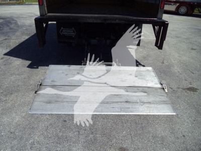 Isuzu NPR HD rear with lowered aluminum ramp/step and tailgate in view; truck bed area shows metal ramp deployed.