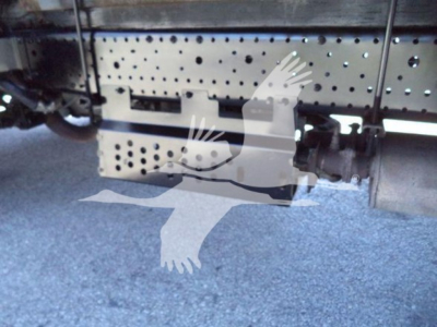 Isuzu NPR HD truck undercarriage showing perforated metal frame and hitch area