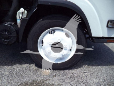 Isuzu NPR HD truck wheel and front fender showing front wheel with hubcap and tire, part of box truck body
