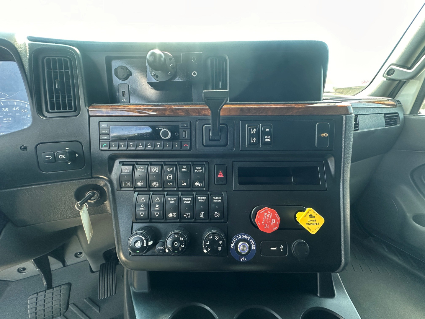 Cockpit view of 2021 International LT625 dashboard with controls, gauges, and gear selector.