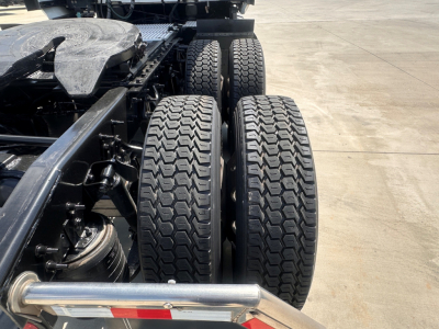 Truck rear dual rear axles with heavy-duty dual tires and suspension visible in the chassis of a 2021 International LT625.