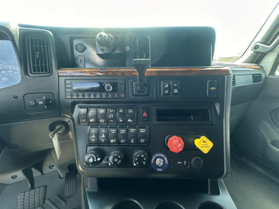 Cockpit view of 2021 International LT625 dashboard with controls, gauges, and gear selector.