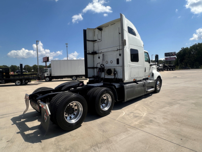 International LT625 semi truck tractor rear and side view showing sleeper cab, dual rear axles, fifth-wheel, and exhaust stack.