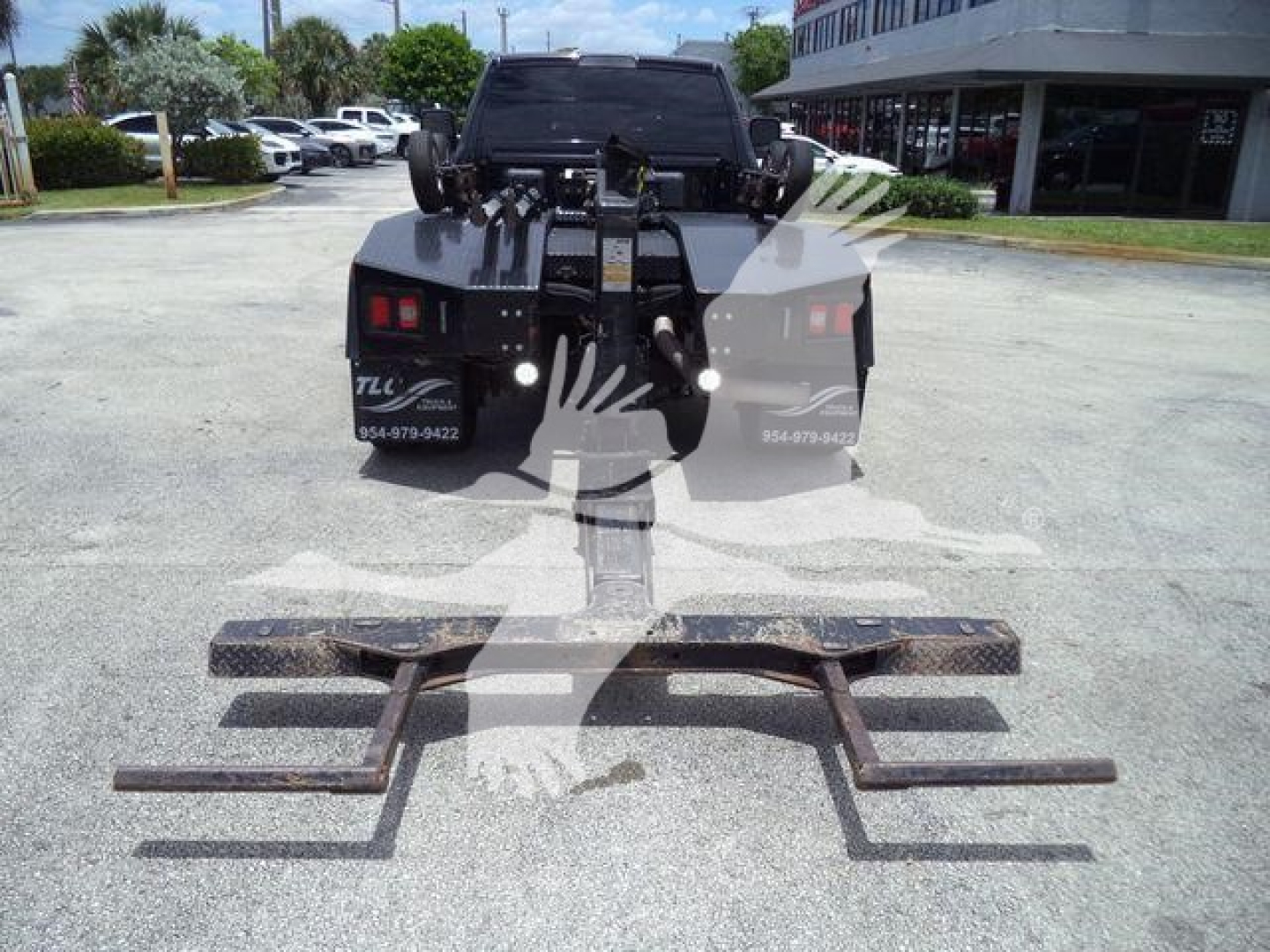 Ram 4500 SLT back view with heavy-duty winch and mounting system on truck bed, including multiple towing hooks and metal brackets in foreground.