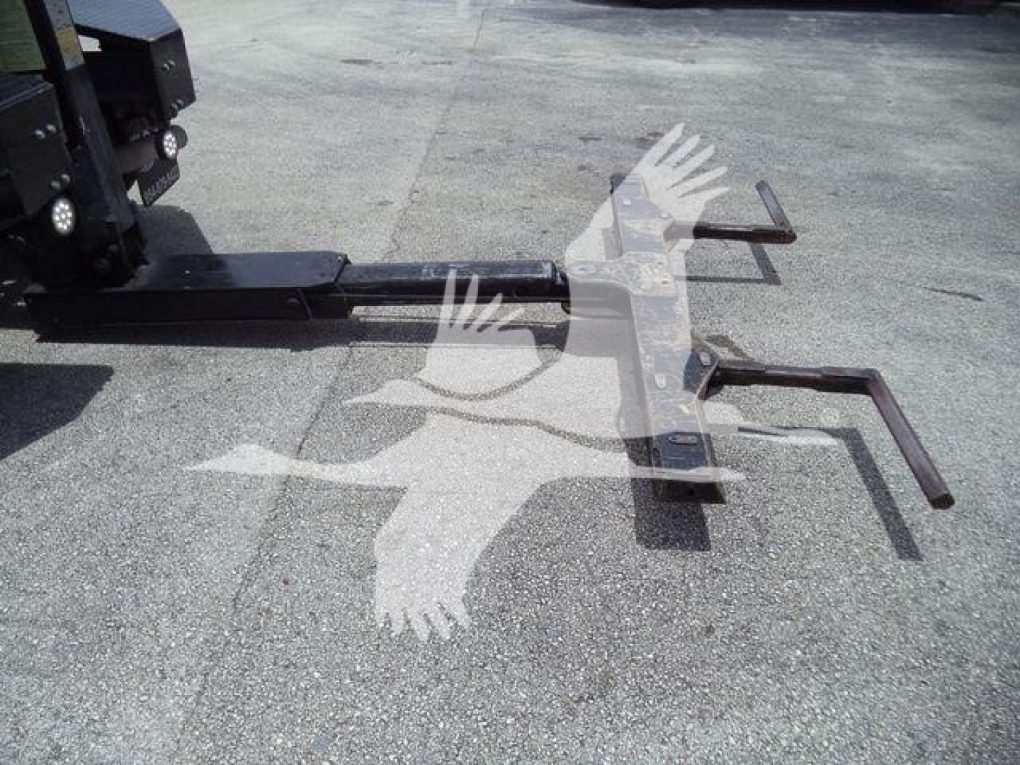 Ram 4500 winch hitch attachment with black steel components sited on pavement, visible tow hooks and mounting frame.
