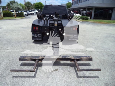 Ram 4500 SLT back view with heavy-duty winch and mounting system on truck bed, including multiple towing hooks and metal brackets in foreground.