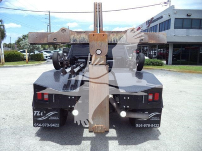Ram 4500 tow truck bed with hitch and winch behind the rear wheels, metal frame and hydraulic components visible.