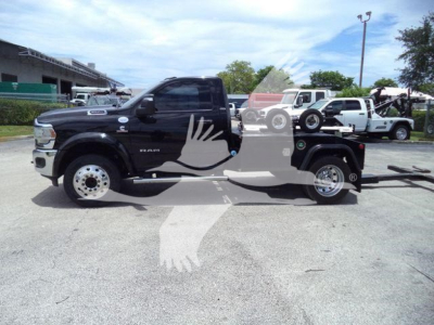 Ram 4500 tow truck with winch, side view showing cab, doors, and flatbed; visible text includes RAM 4500 on door and possible dealer watermark overlay.