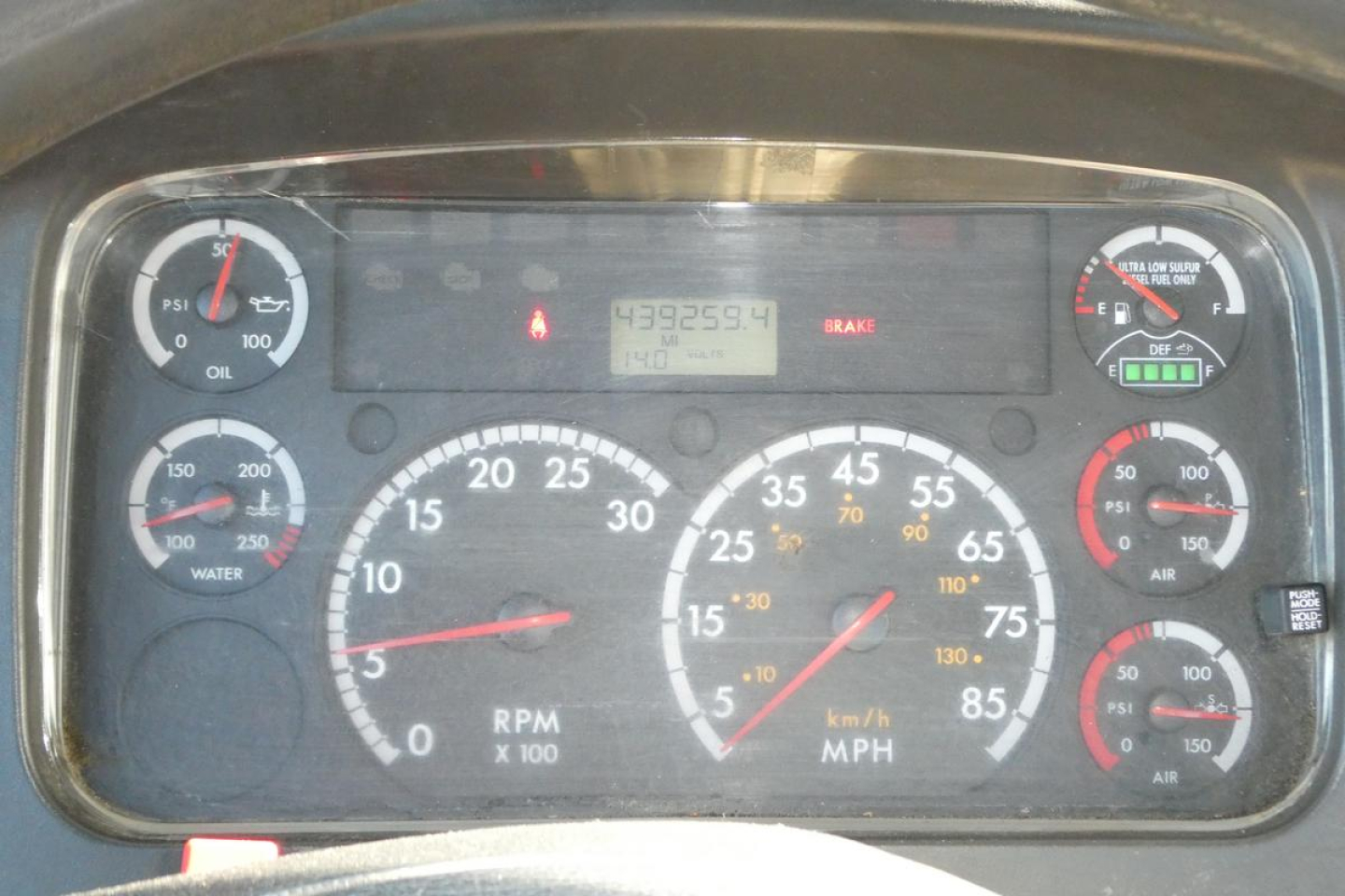 Dashboard cluster of a Freightliner M2 112 showing various gauges and digital readout.