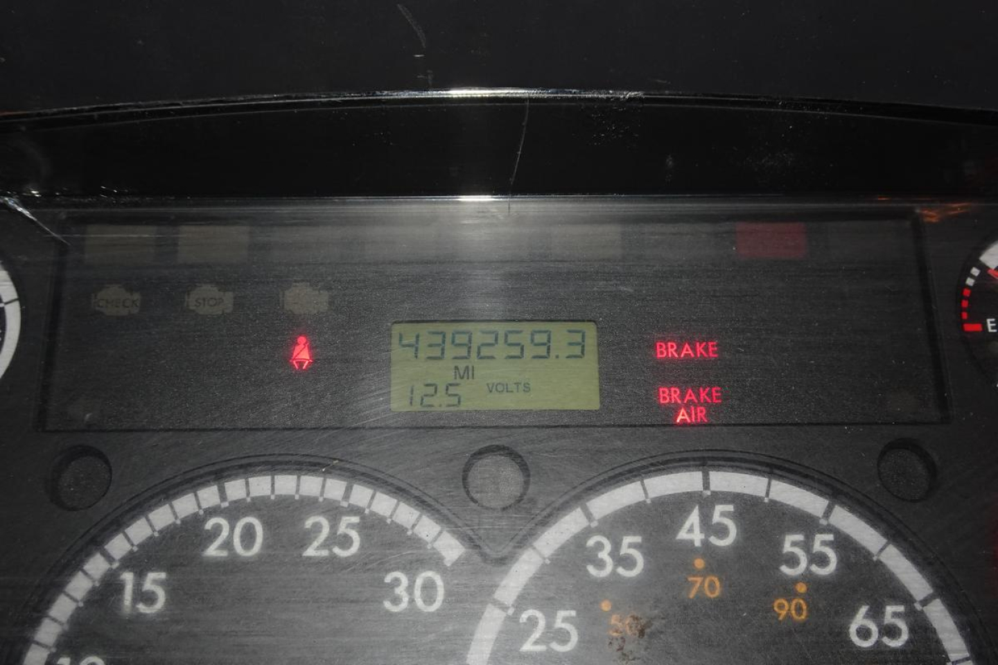Truck dashboard showing odometer reading 439,259.3 miles, 125V? display, brake indicators, and gauge cluster.