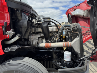 Engine bay of 2019 Freightliner Cascadia 126 showing intercooler piping, radiator, coolant reservoir, and hydraulic/filter components.