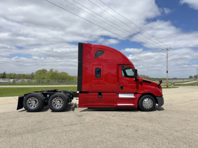 Truck side view showing a red 2019 Freightliner Cascadia 126 sleeper cab with three axles and a low-height chassis.