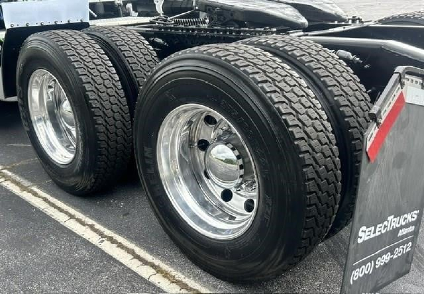 Freightliner Cascadia 126 wheel and dual rear axle tires on a sleeper tractor showing chrome wheels and tire treads.