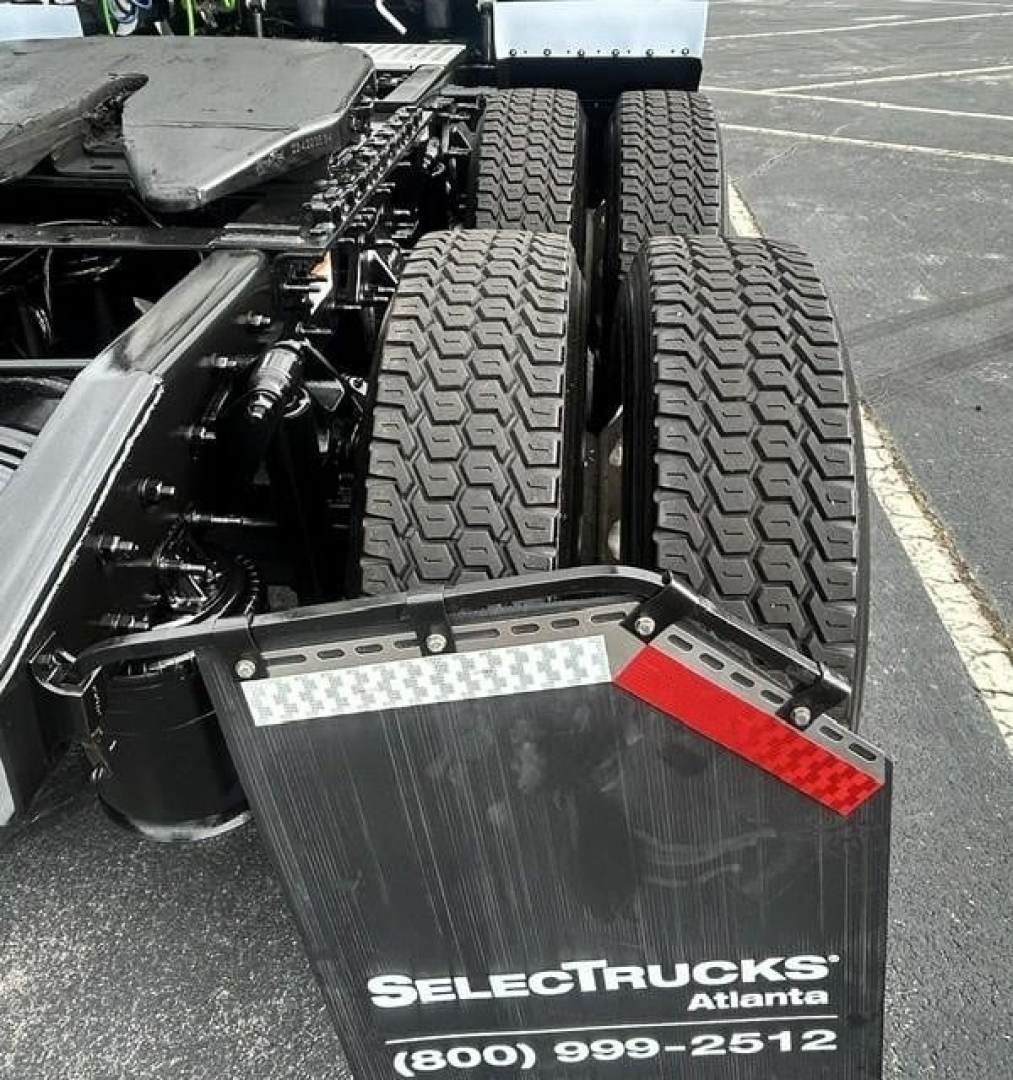 Freightliner Cascadia 126 rear view showing dual rear axles and mud flaps with SelectTrucks Atlanta branding.
