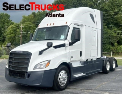 Freightliner Cascadia 126 tractor-trailer cab front-left view with white paint and black bumper; SelectTrucks Atlanta watermark.