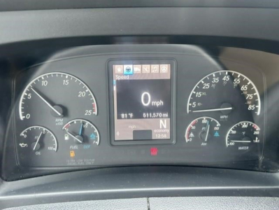 Dashboard of a Freightliner Cascadia 126 showing digital center display with 0 mph, various gauges including speedometer and tachometer, and gear indicator in N.